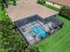 Aerial view of a screened-in pool and jacuzzi with outdoor seating at 603 165Th E St, Bradenton, FL 34212