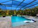 Night view of the pool area featuring a waterfall and tropical garden at 603 165Th E St, Bradenton, FL 34212