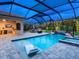 Enjoy this backyard oasis featuring a screened-in pool, spa, outdoor kitchen, and lounge area at 603 165Th E St, Bradenton, FL 34212