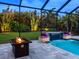 Night view of the fire pit and waterfalls in the backyard pool area at 603 165Th E St, Bradenton, FL 34212