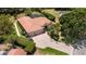 Aerial view of a beautifully landscaped home with a red tile roof and a circular driveway at 6231 Cypress Bend Ct, University Park, FL 34201