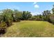 Expansive, private backyard with lush greenery and mature trees, providing a peaceful retreat at 6231 Cypress Bend Ct, University Park, FL 34201