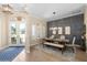 Stylish dining room with natural light, a wooden table set for six, and hardwood floors at 6231 Cypress Bend Ct, University Park, FL 34201