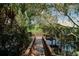 Community kayak launch through lush foliage leading to the water at 6231 Cypress Bend Ct, University Park, FL 34201