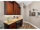 Elegant bar area with custom cabinets, granite countertops, a wine cooler, and a stylish tile backsplash at 6231 Cypress Bend Ct, University Park, FL 34201