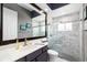 Beautifully renovated bathroom featuring a glass enclosed shower, with gray and white marble tile at 6231 Cypress Bend Ct, University Park, FL 34201