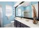 Charming bathroom with a light-blue painted walls, a shower, and a white countertop vanity at 6231 Cypress Bend Ct, University Park, FL 34201