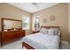 Cozy bedroom with lots of natural light and a large dresser, creating a peaceful retreat at 6231 Cypress Bend Ct, University Park, FL 34201