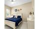Bright bedroom featuring neutral paint, a ceiling fan and coastal décor in this charming home at 6231 Cypress Bend Ct, University Park, FL 34201