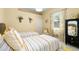 Bright bedroom is styled with twin beds, a window with bright curtains, and stylish decor at 6231 Cypress Bend Ct, University Park, FL 34201