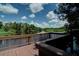 Scenic view from a wooden dock overlooking a tranquil lake surrounded by lush greenery at 6231 Cypress Bend Ct, University Park, FL 34201