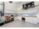 Spacious garage with custom workbench, pegboard organizers, and ample storage cabinets at 6231 Cypress Bend Ct, University Park, FL 34201