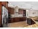 Gourmet kitchen featuring stainless steel appliances, custom cabinets, granite countertops, and modern design at 6231 Cypress Bend Ct, University Park, FL 34201