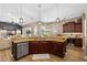 Open kitchen features granite counters, wood cabinets and stainless steel appliances with an eat-in counter at 6231 Cypress Bend Ct, University Park, FL 34201