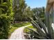 Brick path winds through mature landscaping creating a peaceful walkway to the home's entrance at 6231 Cypress Bend Ct, University Park, FL 34201