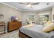 Warm main bedroom features a sliding door access to screened patio and an ample amount of natural light at 6231 Cypress Bend Ct, University Park, FL 34201
