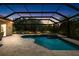 Screened-in pool with a spa is surrounded by a stone deck and lush landscaping at 6231 Cypress Bend Ct, University Park, FL 34201