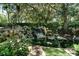 Scenic water feature with a rocky waterfall cascading into a pond surrounded by lush foliage at 6231 Cypress Bend Ct, University Park, FL 34201