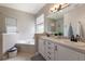 Well-lit bathroom with double vanities, soaking tub, and separate shower, providing a spa-like experience at 6523 Blue Grosbeak Cir, Lakewood Ranch, FL 34202