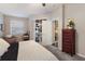 Cozy bedroom featuring an outdoor patio, a dresser, and plush carpet at 6523 Blue Grosbeak Cir, Lakewood Ranch, FL 34202