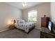 Comfortable bedroom with a nautical theme, natural light, and ample closet space offers a cozy retreat at 6523 Blue Grosbeak Cir, Lakewood Ranch, FL 34202