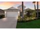 Charming two-story home boasts a well-manicured lawn, lush landscaping, and a spacious two-car garage at 6523 Blue Grosbeak Cir, Lakewood Ranch, FL 34202