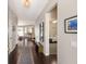 Inviting hallway featuring dark wood floors and neutral wall tones; bright and airy space at 6523 Blue Grosbeak Cir, Lakewood Ranch, FL 34202
