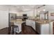 Bright kitchen with white cabinets, stainless steel appliances, and granite countertops is perfect for cooking at 6523 Blue Grosbeak Cir, Lakewood Ranch, FL 34202