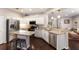 Modern kitchen with stainless steel appliances, granite countertops, and a center island with breakfast bar at 6523 Blue Grosbeak Cir, Lakewood Ranch, FL 34202