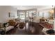 Open-concept living room with hardwood floors, stylish furniture, and plenty of natural light at 6523 Blue Grosbeak Cir, Lakewood Ranch, FL 34202