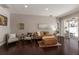 Comfortable living room features hardwood floors, neutral paint, and a sliding glass door to the outdoors at 6523 Blue Grosbeak Cir, Lakewood Ranch, FL 34202
