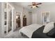 Bright main bedroom with sliding door access, ceiling fan, ensuite bathroom, and walk-in closet at 6523 Blue Grosbeak Cir, Lakewood Ranch, FL 34202
