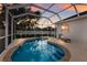 Screened-in pool with brick coping, lounge chairs, and lovely sunset views at 6523 Blue Grosbeak Cir, Lakewood Ranch, FL 34202