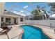 Beautiful pool with screened enclosure, lounge seating, and a manicured lawn at 6523 Blue Grosbeak Cir, Lakewood Ranch, FL 34202