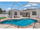 Beautiful screened-in pool with a brick trim, blue water, and an outdoor lounge area at 6523 Blue Grosbeak Cir, Lakewood Ranch, FL 34202