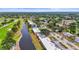 Aesthetic aerial view showcasing waterfront condos, landscaping and mature trees within a golf course community at 7391 W Country Club N Dr, Sarasota, FL 34243