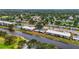 Overhead view of serene waterfront condos amidst mature trees and landscaping, creating a park-like setting at 7391 W Country Club N Dr, Sarasota, FL 34243