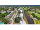 Scenic aerial view of waterfront condos, lush landscaping and a golf course in a vibrant community at 7391 W Country Club N Dr, Sarasota, FL 34243