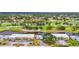Stunning aerial view of the property showcasing its proximity to a golf course and water features at 7391 W Country Club N Dr, Sarasota, FL 34243