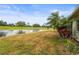 Backyard showcasing a pond view, lush landscaping and beautiful greenery at 7391 W Country Club N Dr, Sarasota, FL 34243