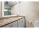 Bathroom with a white vanity with granite countertops, sink, mirror, and toilet at 7391 W Country Club N Dr, Sarasota, FL 34243