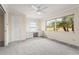 Bright, sunlit bedroom offering a built-in desk area, large windows with outdoor views, and ample closet space at 7391 W Country Club N Dr, Sarasota, FL 34243