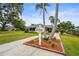 The Palm Aire Golf Side Clubhouse featuring a manicured lawn and inviting entrance at 7391 W Country Club N Dr, Sarasota, FL 34243