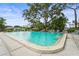 The sparkling community pool is surrounded by ample seating and lush landscaping, a perfect oasis at 7391 W Country Club N Dr, Sarasota, FL 34243