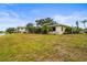Exterior shot of the home showcasing the lake view and landscaping at 7391 W Country Club N Dr, Sarasota, FL 34243