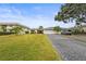 Charming single Gathering home featuring a spacious driveway, manicured lawn and tropical landscaping at 7391 W Country Club N Dr, Sarasota, FL 34243