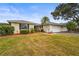 Charming single-story home with well-maintained landscaping, mature trees, and an attached two-car garage at 7391 W Country Club N Dr, Sarasota, FL 34243