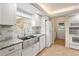 Bright kitchen features stainless steel farmhouse sink, granite countertops, and white cabinetry at 7391 W Country Club N Dr, Sarasota, FL 34243