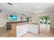 Open floor plan with island features a sink, granite countertops, and seamlessly connects to the living area at 7391 W Country Club N Dr, Sarasota, FL 34243