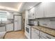 Well-lit kitchen includes white appliances, granite countertops, and ample cabinet space at 7391 W Country Club N Dr, Sarasota, FL 34243